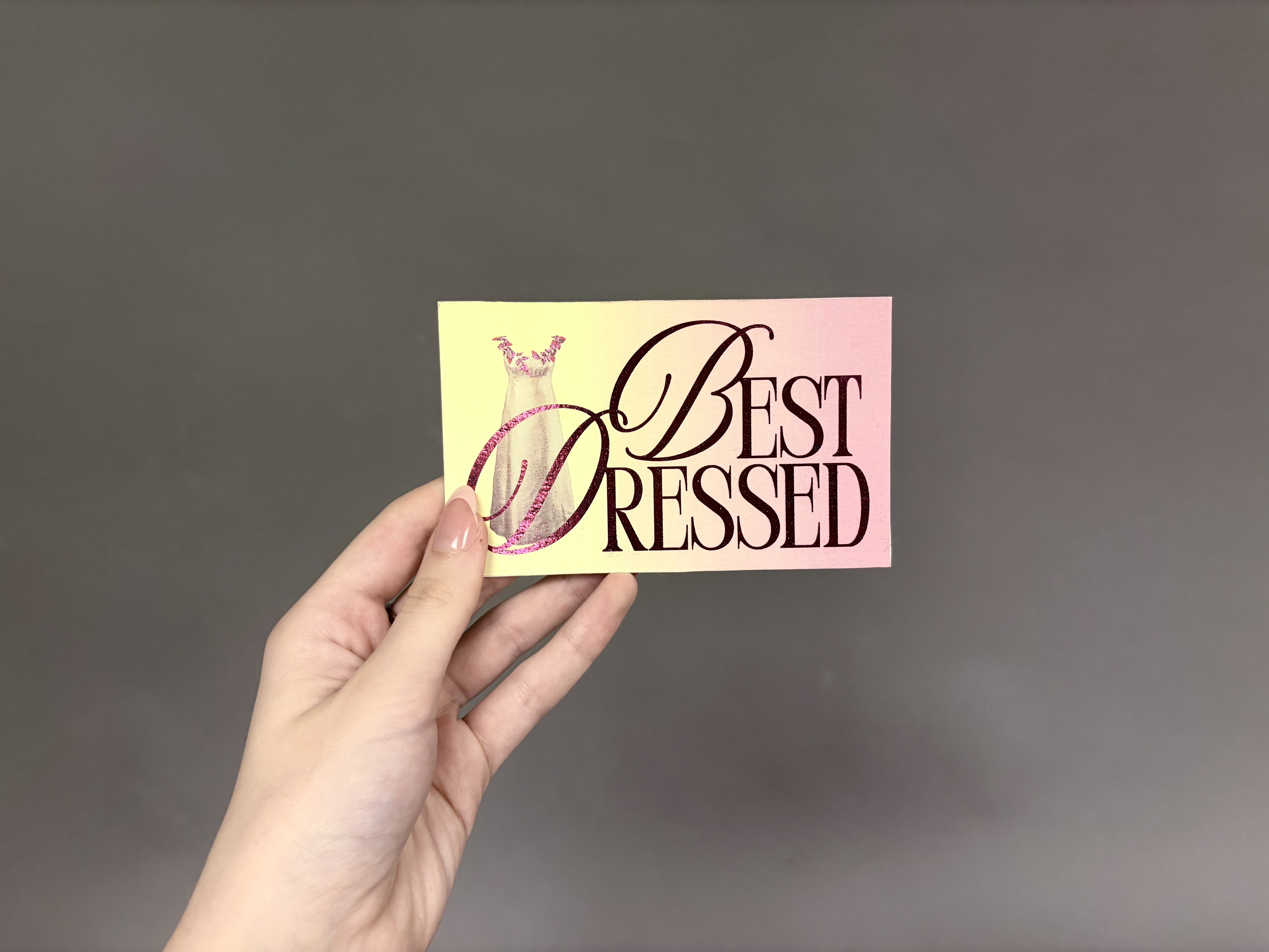 A hand holding the donation card.