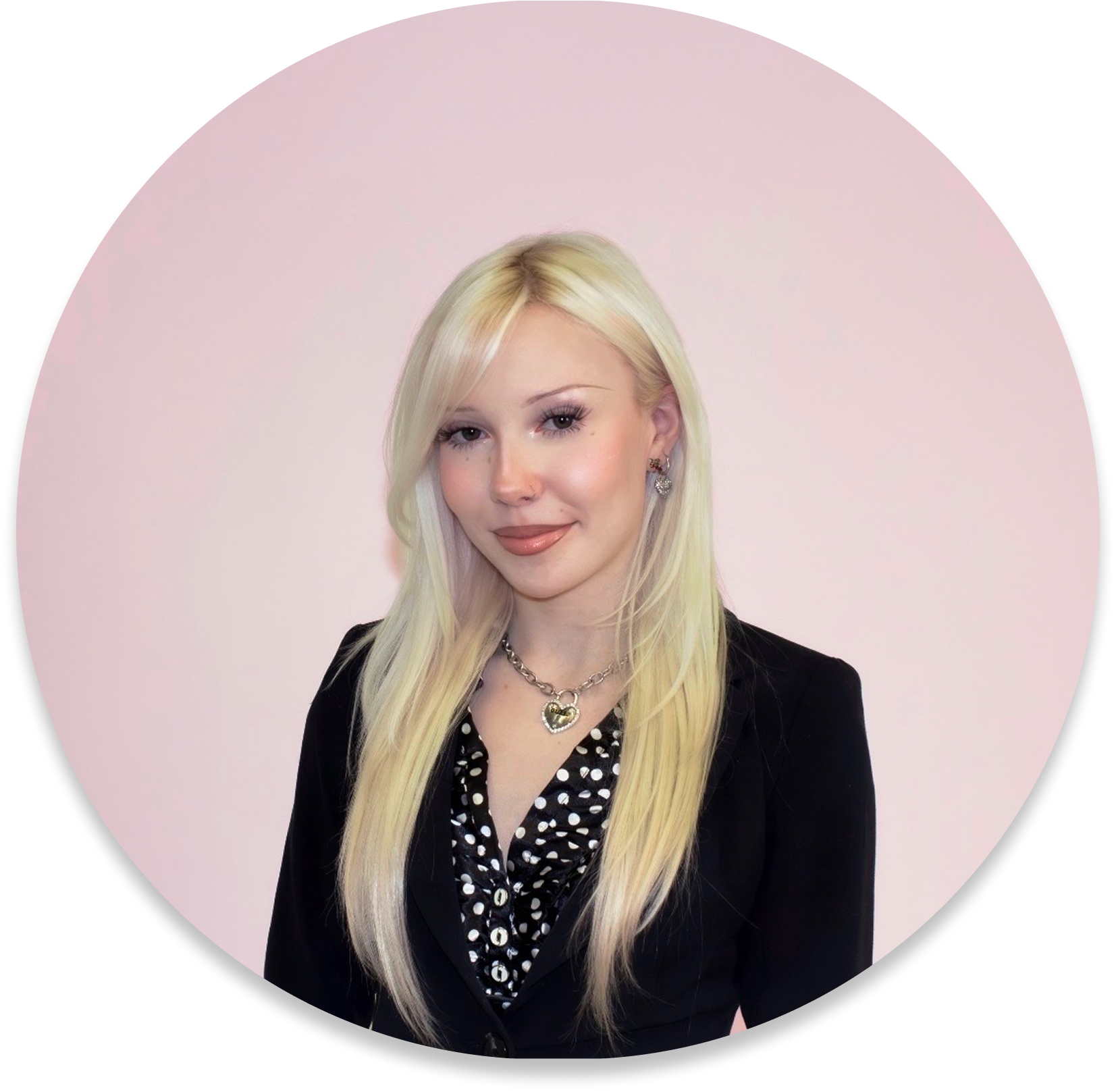 A blonde girl with proffesional attire on and a pink background